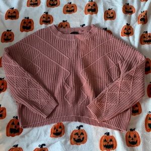 Mauve pink sweater it’s cropped. It is a medium and it is in great condition.